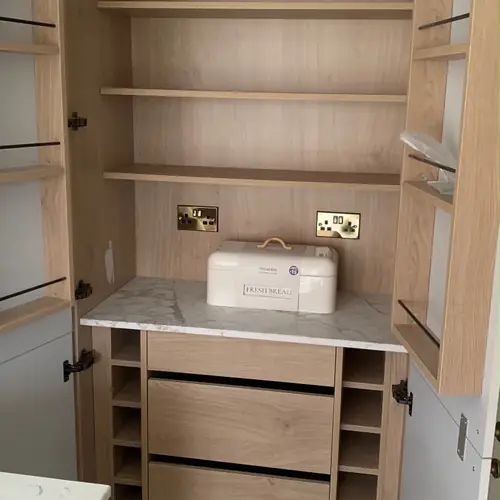 Bespoke larder cupboard with oak shelves and a coffee station