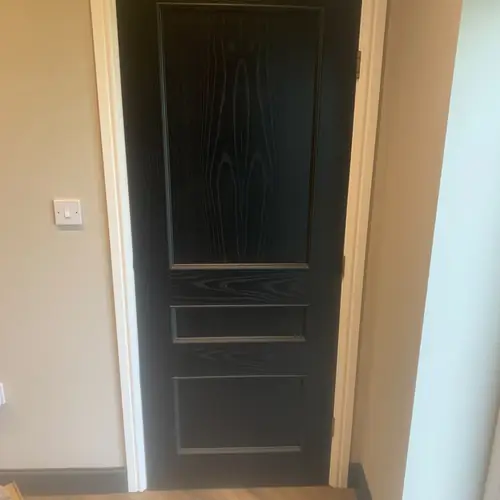 Black panelled internal door with new architrave