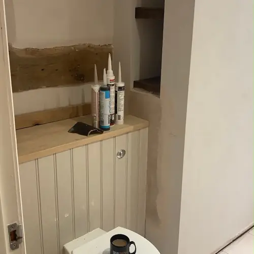 Cloakroom with tongue-and-groove panelling and a vanity unit