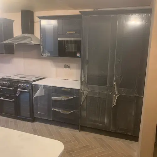 Dark grey kitchen with a range cooker and herringbone floor