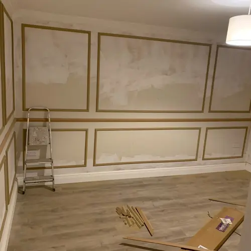 Box wall panelling being fitted in a dining room