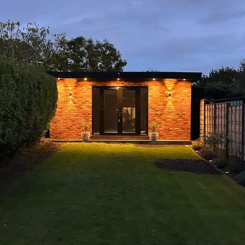 Garden room with brick-slip cladding at dusk