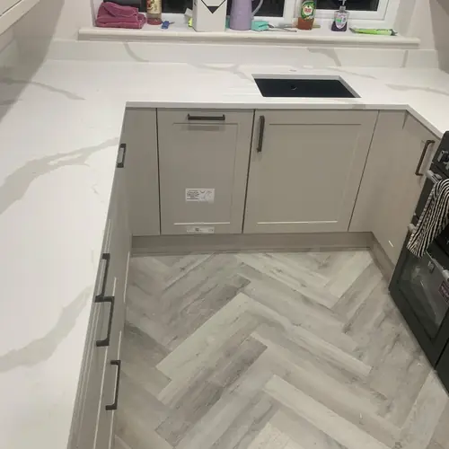 Grey shaker kitchen with quartz worktops and grey herringbone flooring &ndash; one of our recent joinery and building projects