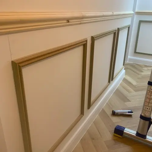 Hallway box panelling with a dado rail over herringbone flooring