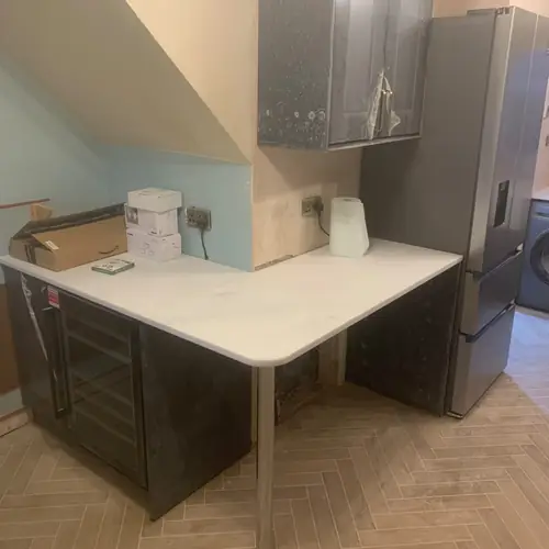 Kitchen corner with a breakfast bar under a sloping ceiling
