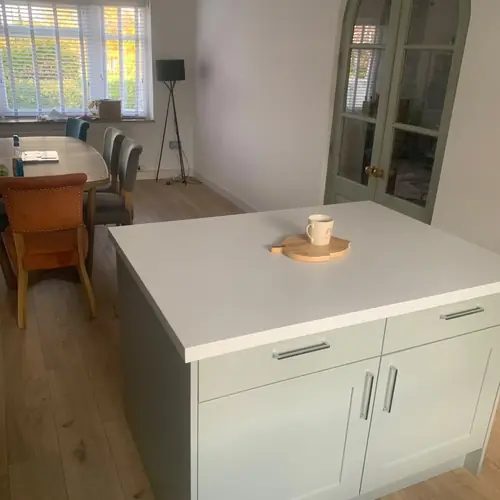 Kitchen island beside an arched glazed door