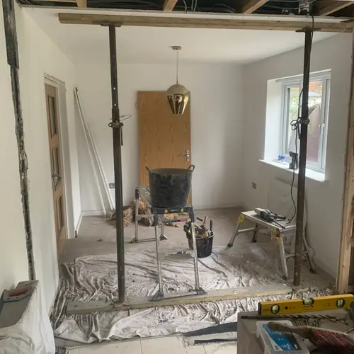 Wall knock-through supported on props during a renovation