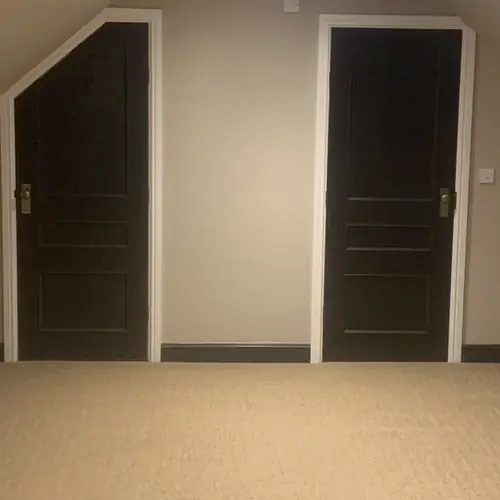 Loft room with dark eaves storage doors