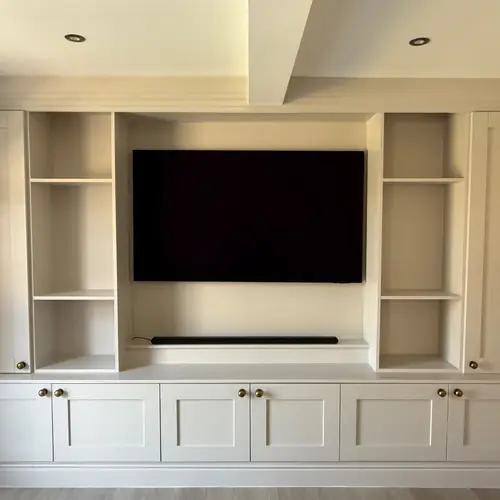 Built-in media wall with shaker cabinets and shelving