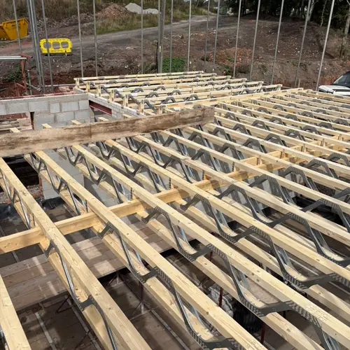 Metal-web floor joists installed on a building plot