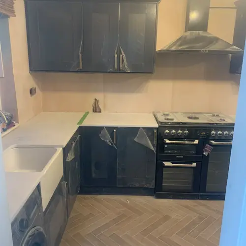 Navy kitchen with a Belfast sink and range cooker