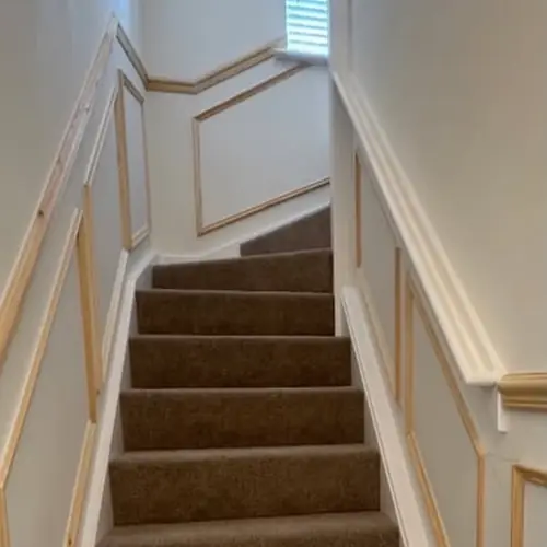 Panelled staircase with a carpet runner