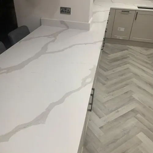 Close-up of a quartz worktop and herringbone floor
