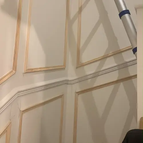 Stairwell wall panelling being fitted before decorating
