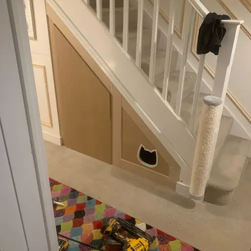 Under-stairs panelling with a built-in pet door