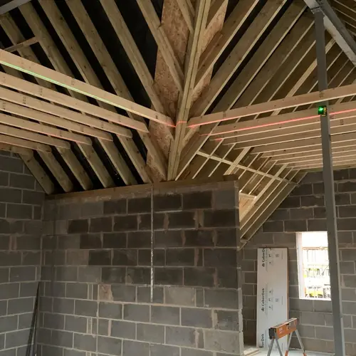 Vaulted roof timbers and blockwork inside a single-storey extension