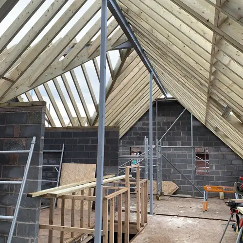 Vaulted roof timbers and scaffolding on a house extension