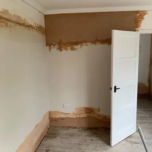 New white internal door hung in a freshly plastered room
