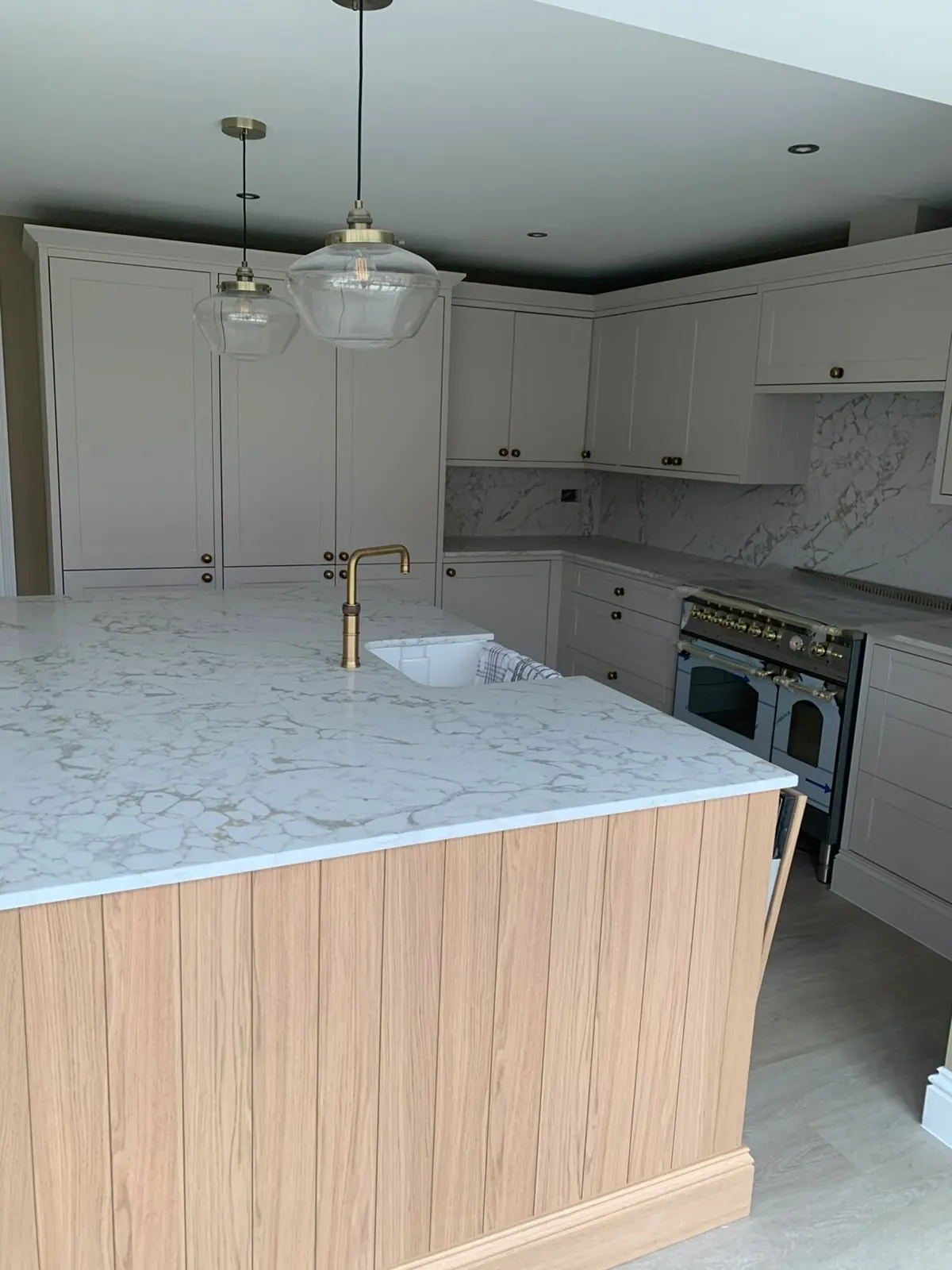 Kitchen island with a timber panel end and quartz worktop
